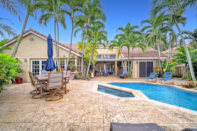 view of pool with an in ground hot tub and a patio area