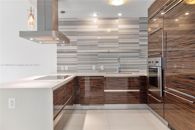 kitchen featuring oven, sink, island range hood, black electric cooktop, and light tile patterned floors