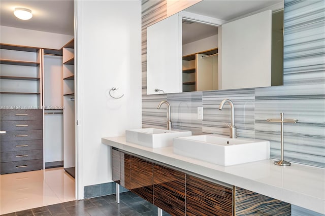 bathroom featuring vanity, decorative backsplash, and tile patterned flooring