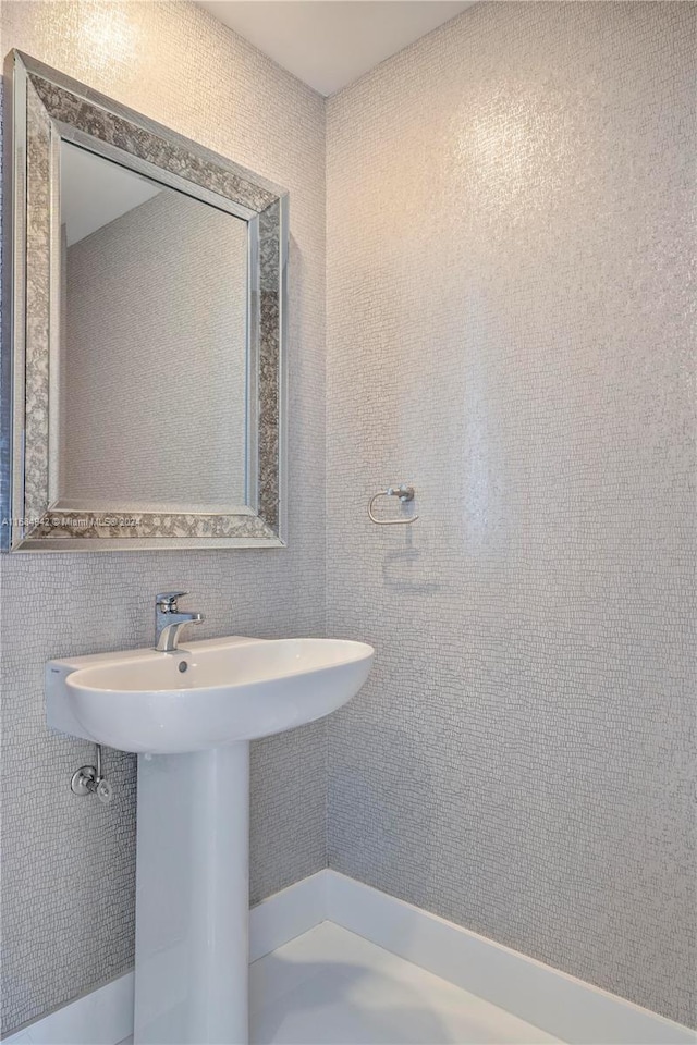 bathroom with tile walls and sink