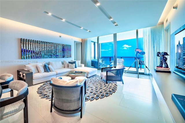 living room featuring a wall of windows and tile patterned floors