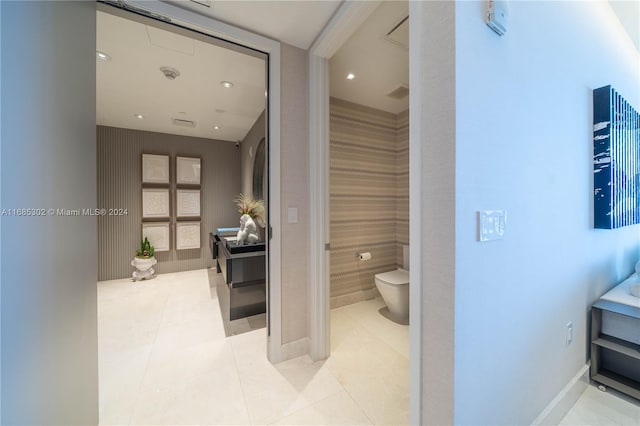 bathroom featuring tile walls, toilet, and tile patterned flooring