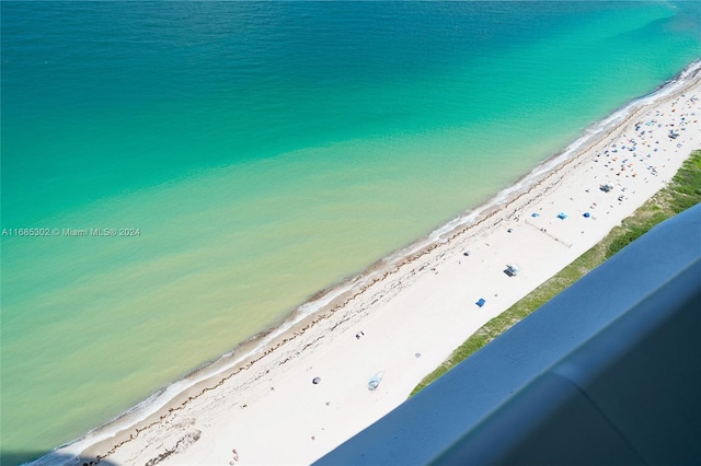 birds eye view of property featuring a water view and a view of the beach