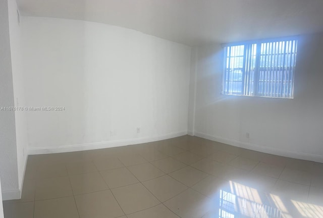 unfurnished room with tile patterned floors