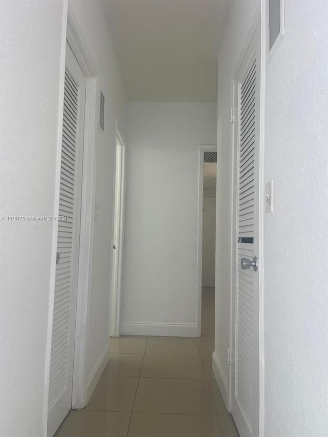 hallway featuring light tile patterned floors