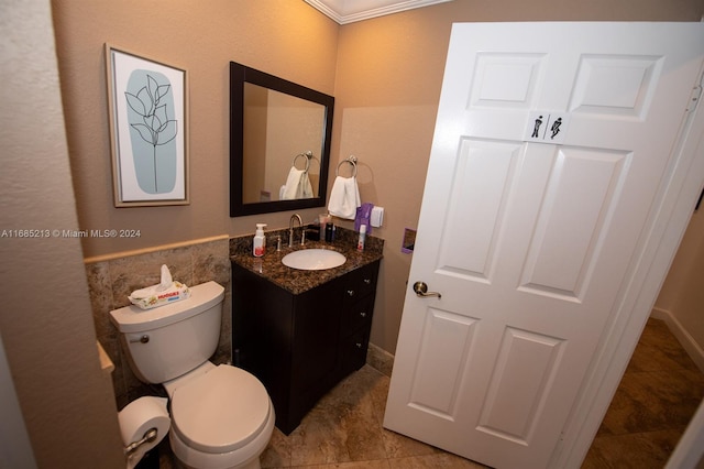 bathroom featuring tile patterned floors, vanity, toilet, and crown molding