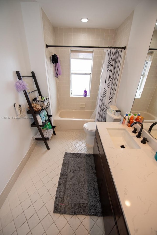 full bathroom featuring tile patterned floors, shower / bath combo with shower curtain, vanity, and toilet