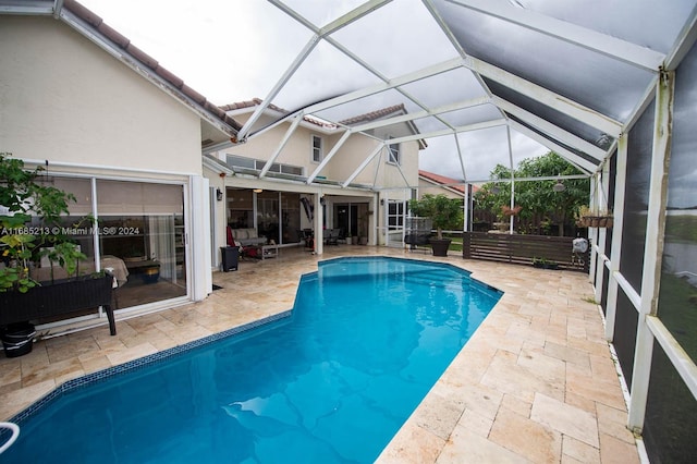 view of swimming pool with a patio and glass enclosure