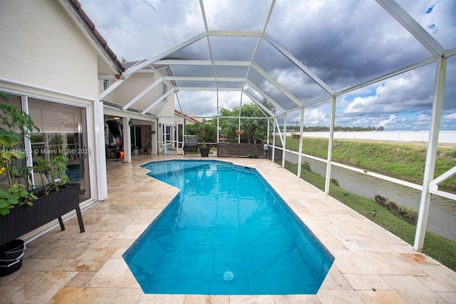 view of swimming pool featuring a lanai and a patio