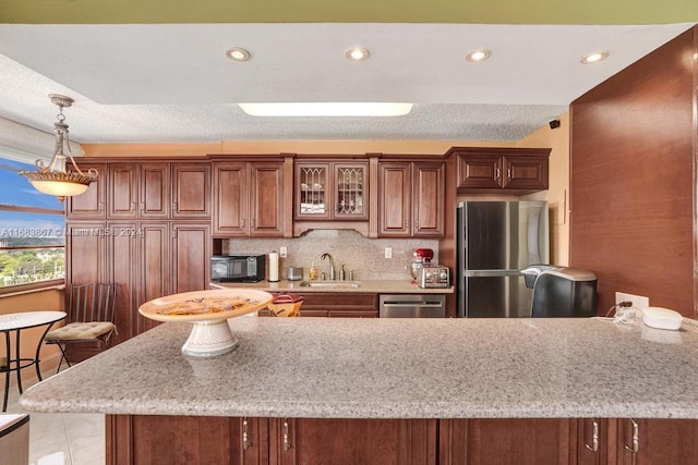 18011 Biscayne Blvd Unit 1705, Aventura, FL 33160 - kitchen featuring stainless steel appliances, decorative light fixtures, decorative backsplash, glass insert cabinets, and recessed lighting
