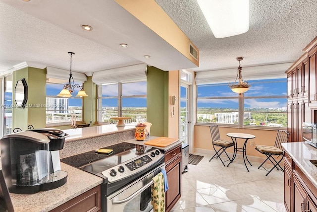18011 Biscayne Blvd Unit 1705, Aventura, FL 33160 - kitchen featuring electric stove, a textured ceiling, hanging light fixtures, brown cabinetry, and light marble finish floors