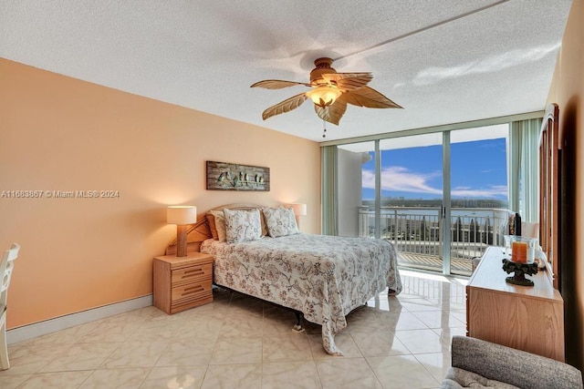 18011 Biscayne Blvd Unit 1705, Aventura, FL 33160 - bedroom with access to exterior, floor to ceiling windows, ceiling fan, a textured ceiling, and a water view