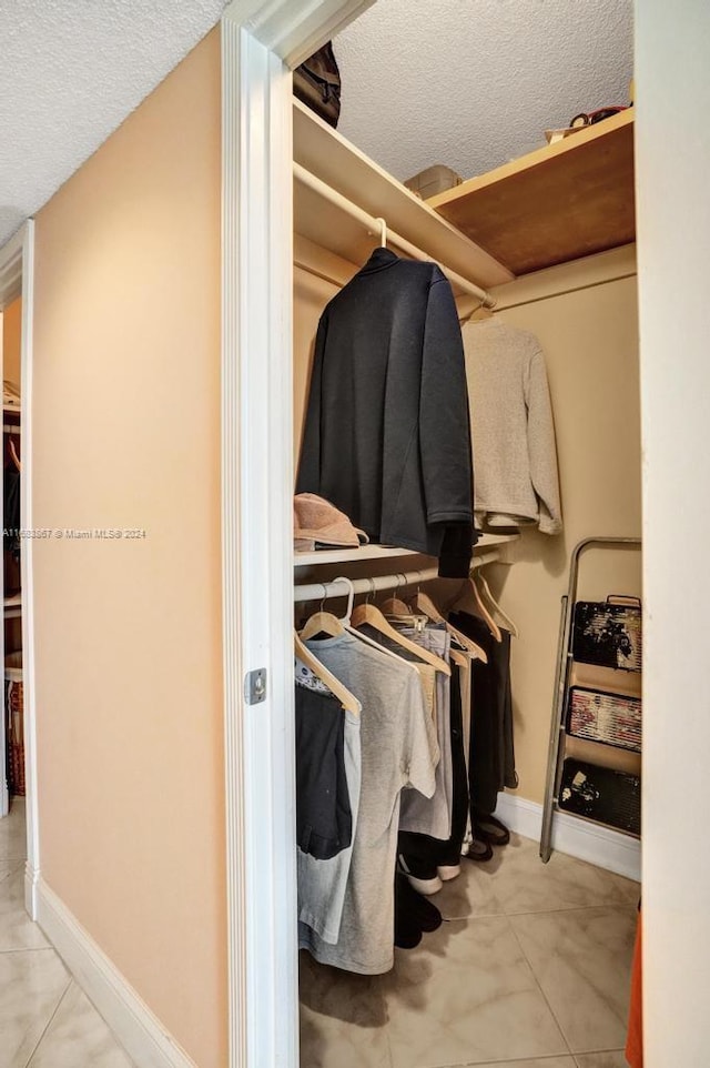 spacious closet with light tile patterned floors