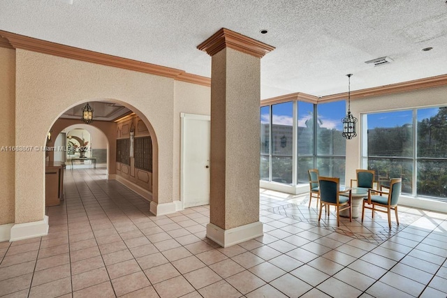 18011 Biscayne Blvd Unit 1705, Aventura, FL 33160 - dining area featuring crown molding, a chandelier, plenty of natural light, arched walkways, and light tile patterned flooring