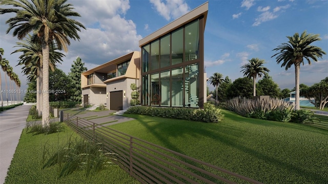 rear view of house featuring a lawn and a balcony