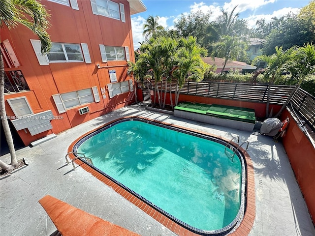 view of swimming pool with a patio area