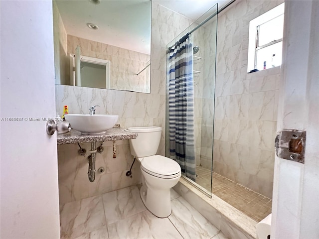 bathroom featuring tile walls, sink, toilet, and a shower with curtain