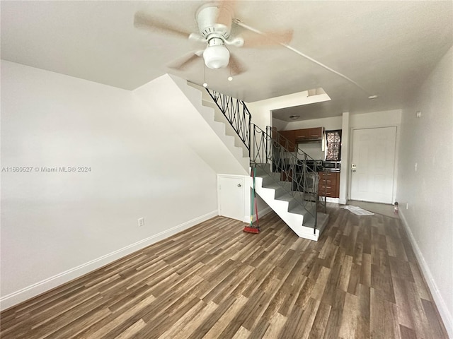 interior space featuring dark wood-type flooring and ceiling fan