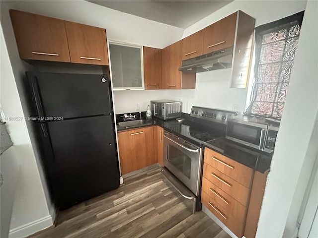 kitchen with appliances with stainless steel finishes, sink, and dark hardwood / wood-style floors