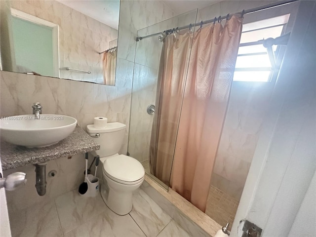 bathroom with a shower with shower curtain, sink, tile walls, and toilet