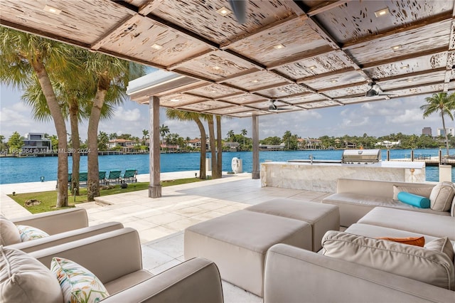 view of patio / terrace featuring grilling area, an outdoor living space, and a water view