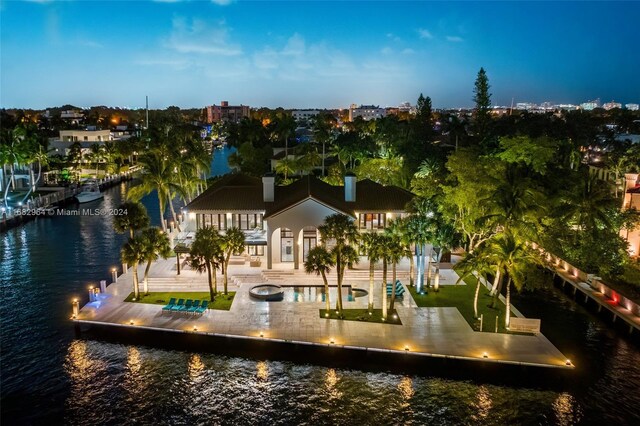 aerial view at dusk with a water view