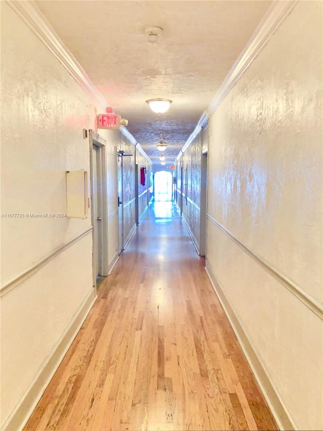 hallway featuring crown molding and wood-type flooring