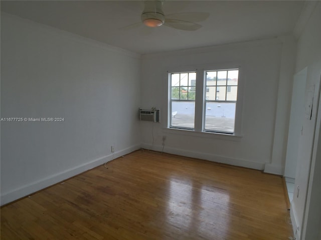 empty room with light hardwood / wood-style floors, crown molding, an AC wall unit, and ceiling fan