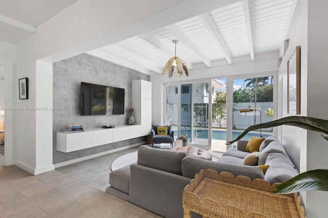 living room featuring beamed ceiling and an inviting chandelier