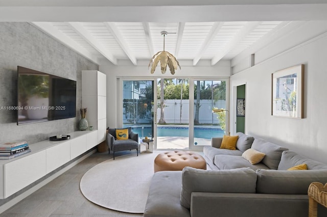 living room featuring an inviting chandelier and beam ceiling