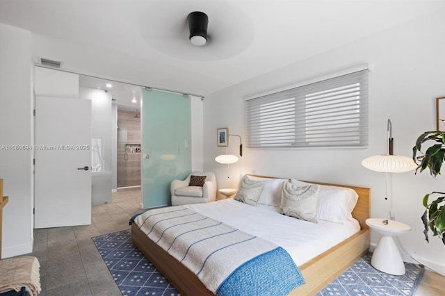 bedroom featuring ceiling fan and ensuite bathroom