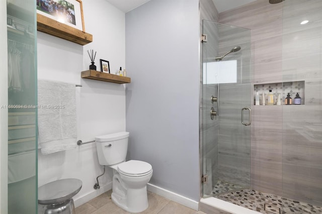 bathroom with a shower with door, tile patterned floors, and toilet