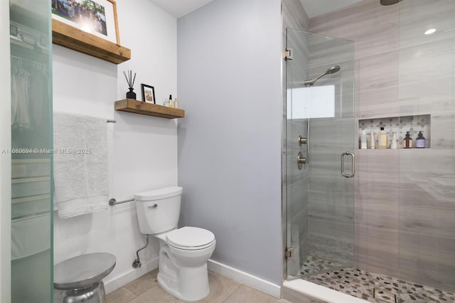 full bath with baseboards, a stall shower, and toilet