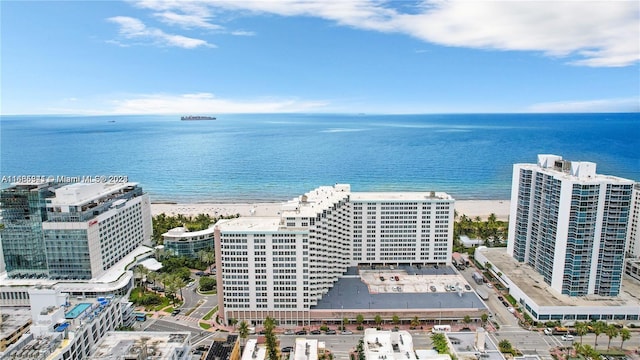 aerial view with a water view and a beach view