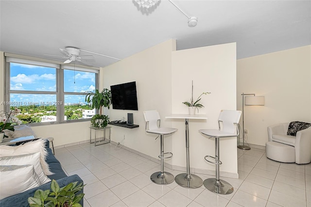 living room featuring ceiling fan and light tile patterned floors