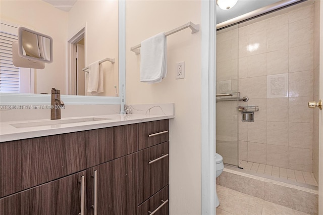 bathroom featuring vanity, toilet, and a shower with shower door