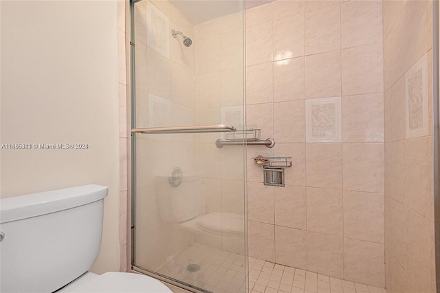 bathroom with toilet and walk in shower