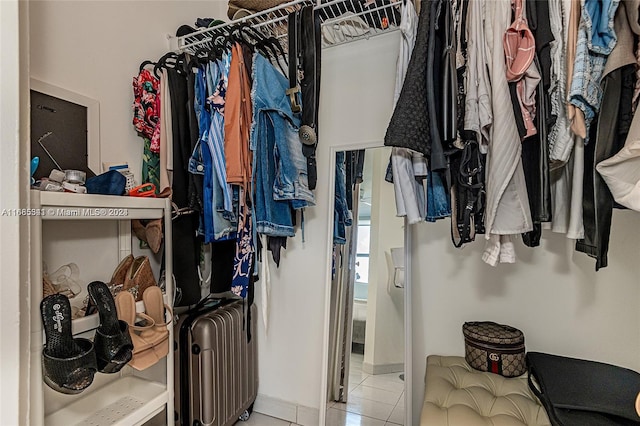 spacious closet with light tile patterned floors