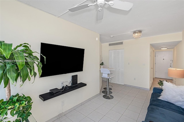 tiled living room featuring ceiling fan