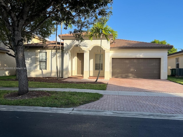 mediterranean / spanish-style home with a garage