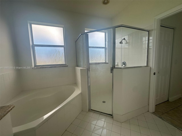 bathroom with tile patterned floors and plus walk in shower