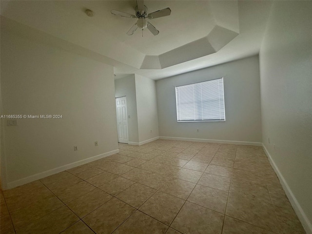 empty room featuring ceiling fan and light tile patterned flooring