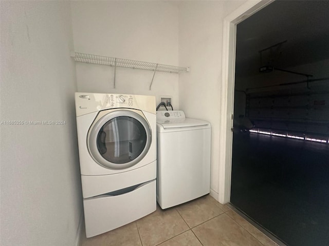 clothes washing area with independent washer and dryer and light tile patterned floors