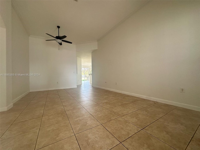 unfurnished room with ceiling fan, light tile patterned floors, and ornamental molding