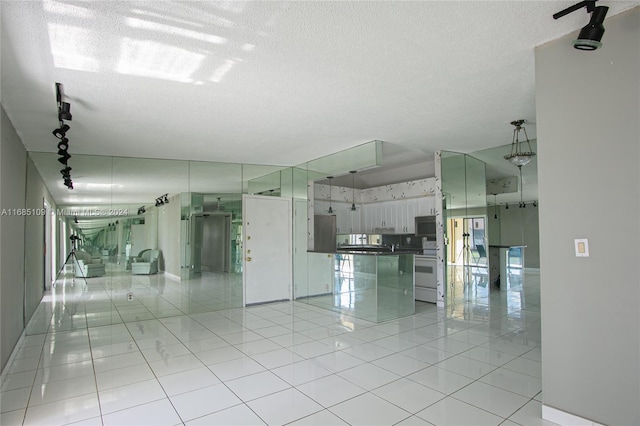 interior space featuring a textured ceiling and rail lighting