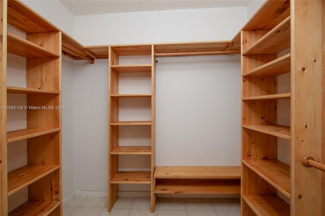 spacious closet featuring light tile patterned floors