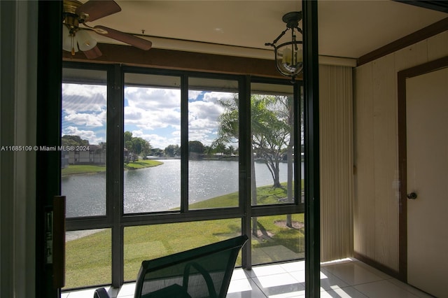 sunroom / solarium with a water view and ceiling fan