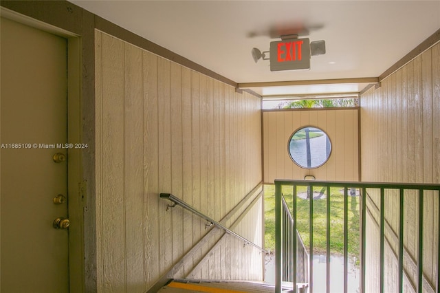 staircase with wood walls