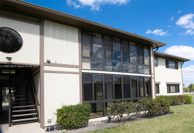 back of property featuring a sunroom