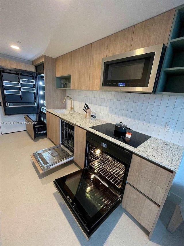 601 Ne 1st 4114, Miami, FL 33132 - kitchen featuring open shelves, stainless steel microwave, black electric cooktop, decorative backsplash, and modern cabinets